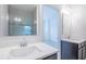Bathroom featuring dual sinks with quartz countertops, dark cabinets, and a tiled shower at 4176 Sagefield Dr, Harmony, FL 34773