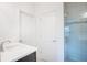 Bathroom featuring a white vanity with quartz countertop and a shower with tiled walls and mosaic accent at 4176 Sagefield Dr, Harmony, FL 34773