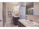 Bathroom featuring double sink vanity with modern fixtures and a tiled shower at 4176 Sagefield Dr, Harmony, FL 34773