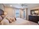 Comfortable bedroom with a large window, soft bedding, and dark wood accents at 4176 Sagefield Dr, Harmony, FL 34773