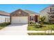 Charming single-Gathering home showcasing a stone facade, two-car garage and a well-manicured lawn at 4176 Sagefield Dr, Harmony, FL 34773