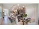 Open concept kitchen with granite countertops, stainless steel appliances, and adjacent dining area at 4176 Sagefield Dr, Harmony, FL 34773