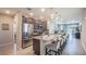 Open kitchen with granite counters, stainless steel appliances, and seating at the island at 4176 Sagefield Dr, Harmony, FL 34773