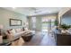 Comfortable living room with a large window, neutral tones, and access to outdoor views at 4176 Sagefield Dr, Harmony, FL 34773