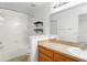 Bright bathroom featuring a tub, shower, and a vanity with sink and decorative shelving at 435 Tradition Ln, Winter Springs, FL 32708