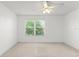 Spacious bedroom illuminated by a ceiling fan and a large window view at 435 Tradition Ln, Winter Springs, FL 32708