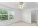 Bedroom with a ceiling fan, window and a closet for organized storage at 435 Tradition Ln, Winter Springs, FL 32708