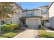 Charming townhome featuring a one car garage, covered entry and manicured landscaping at 435 Tradition Ln, Winter Springs, FL 32708