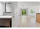 Living area features tile flooring, access to powder bath, and sliding glass doors to the lanai at 435 Tradition Ln, Winter Springs, FL 32708