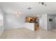 Open-concept living space includes the kitchen with stainless steel appliances, a dining area, and views of backyard at 435 Tradition Ln, Winter Springs, FL 32708