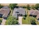 Aerial view of home featuring neutral exterior paint, manicured lawn, and a spacious driveway at 4536 Barrister Dr, Clermont, FL 34711
