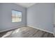 Cozy bedroom featuring wood-look floors and a bright window with blinds at 4536 Barrister Dr, Clermont, FL 34711