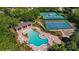 Aerial view of the community pool with a separate hot tub and tennis and basketball courts nearby at 4536 Barrister Dr, Clermont, FL 34711