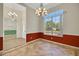 Formal dining room featuring a large window, chandelier, and tile flooring at 4536 Barrister Dr, Clermont, FL 34711