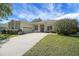 Beautiful home featuring a well-manicured lawn, mature landscaping, and an attached garage at 4536 Barrister Dr, Clermont, FL 34711