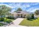 Charming single-story home with well-manicured lawn, lush landscaping, and a long driveway at 4536 Barrister Dr, Clermont, FL 34711