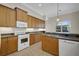Bright kitchen with stainless steel appliances, ample wood cabinets, and views of the outdoor pool area at 4536 Barrister Dr, Clermont, FL 34711