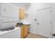 Functional laundry room with a stacked washer and dryer unit and storage cabinets at 4536 Barrister Dr, Clermont, FL 34711