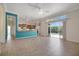 Spacious living room with sliding glass doors to the pool, open to the kitchen with a breakfast bar at 4536 Barrister Dr, Clermont, FL 34711