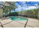 Screened-in pool with a built-in spa and a beautiful blue sky above at 4536 Barrister Dr, Clermont, FL 34711