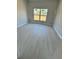 Bright bedroom featuring wood-look flooring and a window providing ample natural light at 4537 Conley St, Orlando, FL 32811