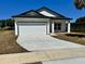 Beautiful single-Gathering home with a white exterior, a garage and a well-manicured lawn under a clear, sunny sky at 4537 Conley St, Orlando, FL 32811