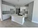 Bright kitchen featuring white cabinets, a center island with a sink, and modern fixtures creating a stylish space at 4537 Conley St, Orlando, FL 32811