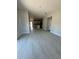 Open-concept living room with hardwood floors leads to a modern kitchen, creating a bright and inviting atmosphere at 4537 Conley St, Orlando, FL 32811