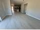 Spacious living area with hardwood floors that transitions into a modern kitchen, illuminated by natural light at 4537 Conley St, Orlando, FL 32811