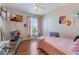 Bedroom featuring hardwood floors and a fan at 5578 Metrowest Blvd # 310, Orlando, FL 32811