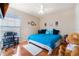Comfortable bedroom boasts natural light, ceiling fan, and hardwood floors to create a relaxing atmosphere at 5578 Metrowest Blvd # 310, Orlando, FL 32811