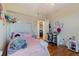 Bright bedroom featuring hardwood floors, a desk space, and cozy decor for a comfortable living space at 5578 Metrowest Blvd # 310, Orlando, FL 32811