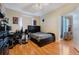 Bedroom featuring hardwood floors, nice bed and fan at 5578 Metrowest Blvd # 310, Orlando, FL 32811