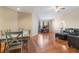 Dining area with hardwood floors, gray dining table, and view of the living room at 5578 Metrowest Blvd # 310, Orlando, FL 32811