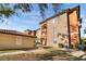 Inviting multi-story condo complex featuring lush landscaping, tile roofs, and walkways to explore the community at 5578 Metrowest Blvd # 310, Orlando, FL 32811