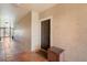 Hallway leading to condo featuring tile floor, dark door, and wooden storage container at 5578 Metrowest Blvd # 310, Orlando, FL 32811