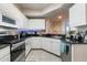 Well-lit kitchen featuring white cabinets, granite countertops, and stainless steel appliances at 5578 Metrowest Blvd # 310, Orlando, FL 32811