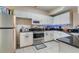 Bright kitchen featuring white cabinets, stainless steel appliances, and granite countertops at 5578 Metrowest Blvd # 310, Orlando, FL 32811
