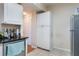 Kitchen features white cabinets, stainless steel refrigerator, and tile floor at 5578 Metrowest Blvd # 310, Orlando, FL 32811