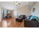 Bright living room featuring hardwood floors, high ceiling, ceiling fan, sofas and a television at 5578 Metrowest Blvd # 310, Orlando, FL 32811