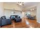 Living room and dining area with hardwood floors, gray sofas, and dining table at 5578 Metrowest Blvd # 310, Orlando, FL 32811
