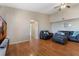 Bright living room with hardwood floors, gray sofas, and neutral paint at 5578 Metrowest Blvd # 310, Orlando, FL 32811