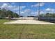 Outdoor volleyball court, surrounded by lush green grass, available for residents to use at 5578 Metrowest Blvd # 310, Orlando, FL 32811