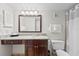 Well-lit bathroom showcasing a vanity with granite countertop, mirror, and shower with curtain at 6403 Parc Corniche Dr # 4204, Orlando, FL 32821