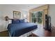 Relaxing bedroom featuring a plush bed, a TV, and a window overlooking the greenery outside at 6403 Parc Corniche Dr # 4204, Orlando, FL 32821