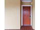 Condo unit 4204 has a red front door with white trim and is set in a textured beige stucco wall at 6403 Parc Corniche Dr # 4204, Orlando, FL 32821