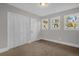 Bedroom with carpet, white trim and windows providing natural light and a closet with folding doors at 719 Se 24Th St, Ocala, FL 34471