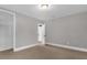 Neutral bedroom featuring carpet, a door leading to another room and a built-in shelving unit at 719 Se 24Th St, Ocala, FL 34471