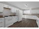 Classic kitchen featuring white cabinetry, granite countertops, and modern appliances at 719 Se 24Th St, Ocala, FL 34471