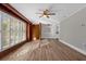 Spacious living room featuring beautiful wood floors, built-in shelves, and plantation shutters for natural light at 719 Se 24Th St, Ocala, FL 34471